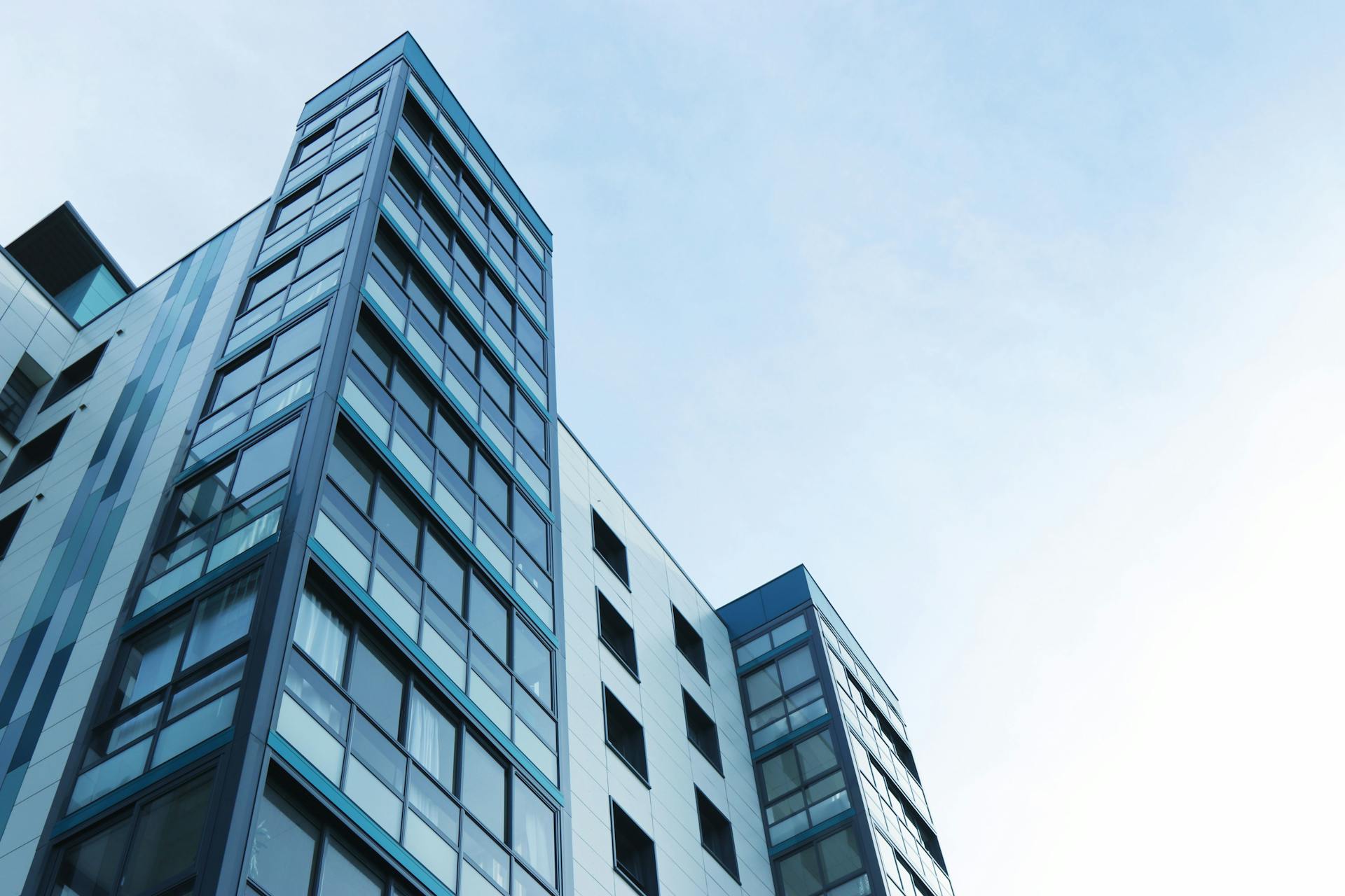 Modern high-rise façade with reflective glass curtain wall